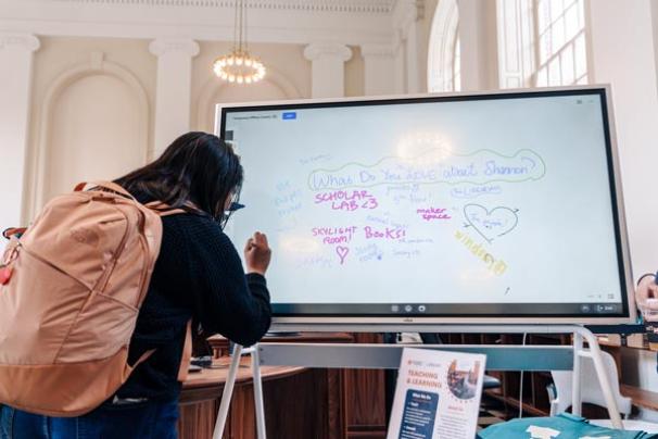 Person signing an electronic whiteboard in Edgar Shannon Library